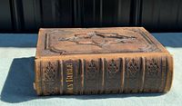 Front cover view showing tooled leather and raised central motif