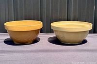 Two yellowware bowls side by side showing exterior color and shape