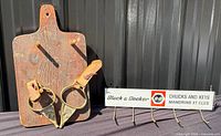 Group shot of wooden peg board, pair of brass stirrups, and Black & Decker hook rack
