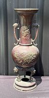 Full view of bronze vase on integral stand