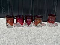Five ruby flash glass cups side by side