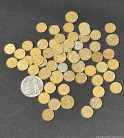 Group of coins and medal spread on dark background