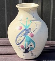 Front view of cream stoneware vase with painted abstract motif