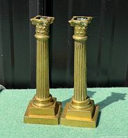 Front view of both candlesticks showing column design and bases