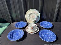 Group shot of entire lot: Crown Ducal plate, Royal Albert trio, four blue floral plates