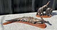Full view of both sculptures against background