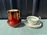 Carlton Ware Rouge Royal vase beside Aynsley cup and saucer