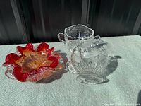Murano ruffled red bowl beside Cornflower creamer and sugar