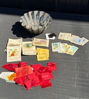 Overview of all items: tin mold, cigarette cards, greeting cards, red prize ribbons