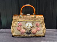 Front view showing wicker body, lucite handle, seashell decoration