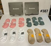 Full lot showing 12 folded pairs in four colors with two Breslatte boxes