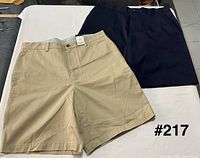 Front view beige and navy shorts side by side