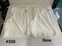Both pairs of white IZOD golf shorts laid flat