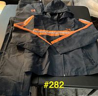 Full view of both jacket and pants laid out together showing color, stripes, graphics