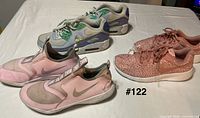 Three Nike youth size 5 pairs side view showing colors and models