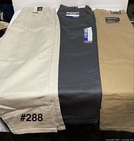 Three pairs pants side-by-side showing colors and tags