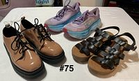 All three pairs grouped: tan lace-ups, purple/blue sneakers, black sandals