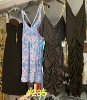 Front view of four dresses hanging