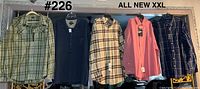 Five new XXL shirts hanging on rail