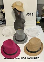 Group shot of all six hats displayed on table and mannequin