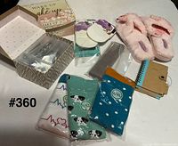 Group shot: slippers, socks, gloves box, headband boxes, notepads