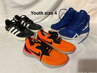 All three pairs of youth size 4 sneakers displayed together