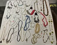 All necklaces and earrings laid out on table