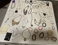 Full lot laid out on table showing necklaces and bracelets