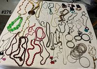 Full lot spread on table showing necklaces and bracelets