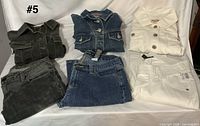 Six garments laid out showing colors and styles