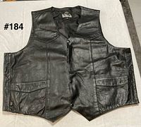 Front view of black leather vest showing pockets and snap closure