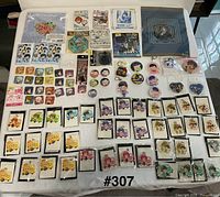 Overview of sealed anime keychains, pins, folders and stickers