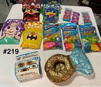Group shot of all packs of bubble gloves, water balloons and floats