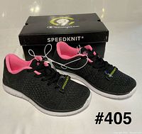 Pair of black and pink Champion Speedknit sneakers with box front view