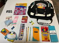 Overview showing backpack and all packaged school supplies laid out on table