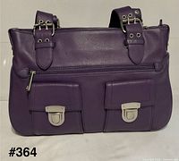 Front view showing pockets, clasp hardware, overall condition