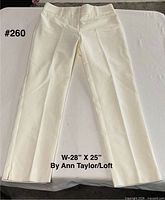 Front view of cream pants laid flat showing full length and waistband
