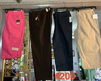 Four pairs of pants hanging: pink, brown, dark blue, beige