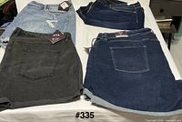 Four denim garments laid out showing colors and styles