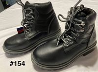 Side view of both boots showing overall design, laces, padded collar, embossed logo