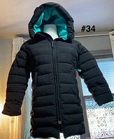 Front view of black puffer coat with hood