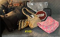 Group shot showing nine assorted bags on couch