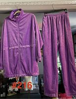 Sweatsuit jacket and pants hung for full view