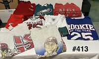 All eight sports shirts laid out together