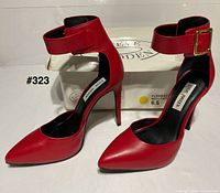 Front and side view of both red Steve Madden heels with box