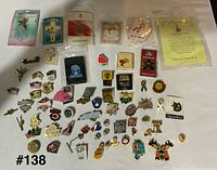 Overview of entire pin collection spread out, showing quantity and variety