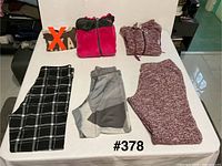 All five clothing items laid out on table