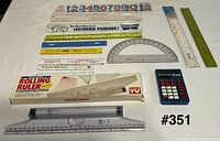 Group image of calculator, Rolling Rulers, assorted straight rulers and protractor