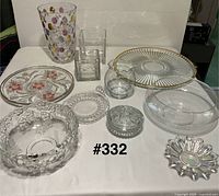 Group shot of all eleven clear glass items laid out and numbered #332