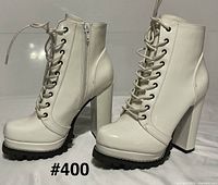 pair of white lace-up block heel boots front and side view